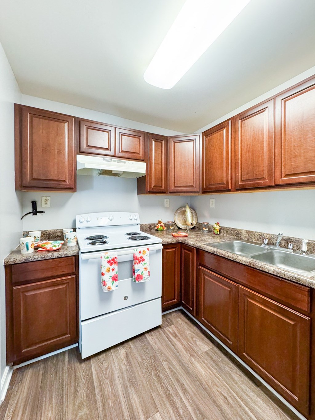 a kitchen with white appliances and wooden cabinets
